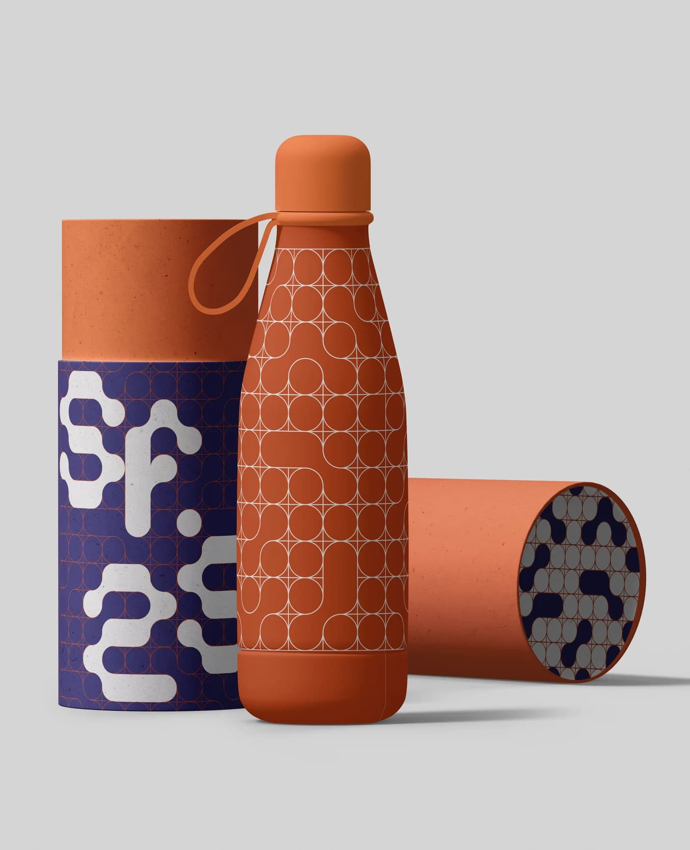A patterned bottle between two tubes carrying the logotype