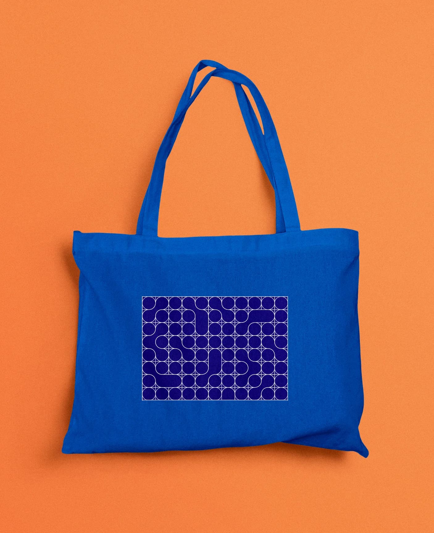 A blue tote printed with the pattern, on orange