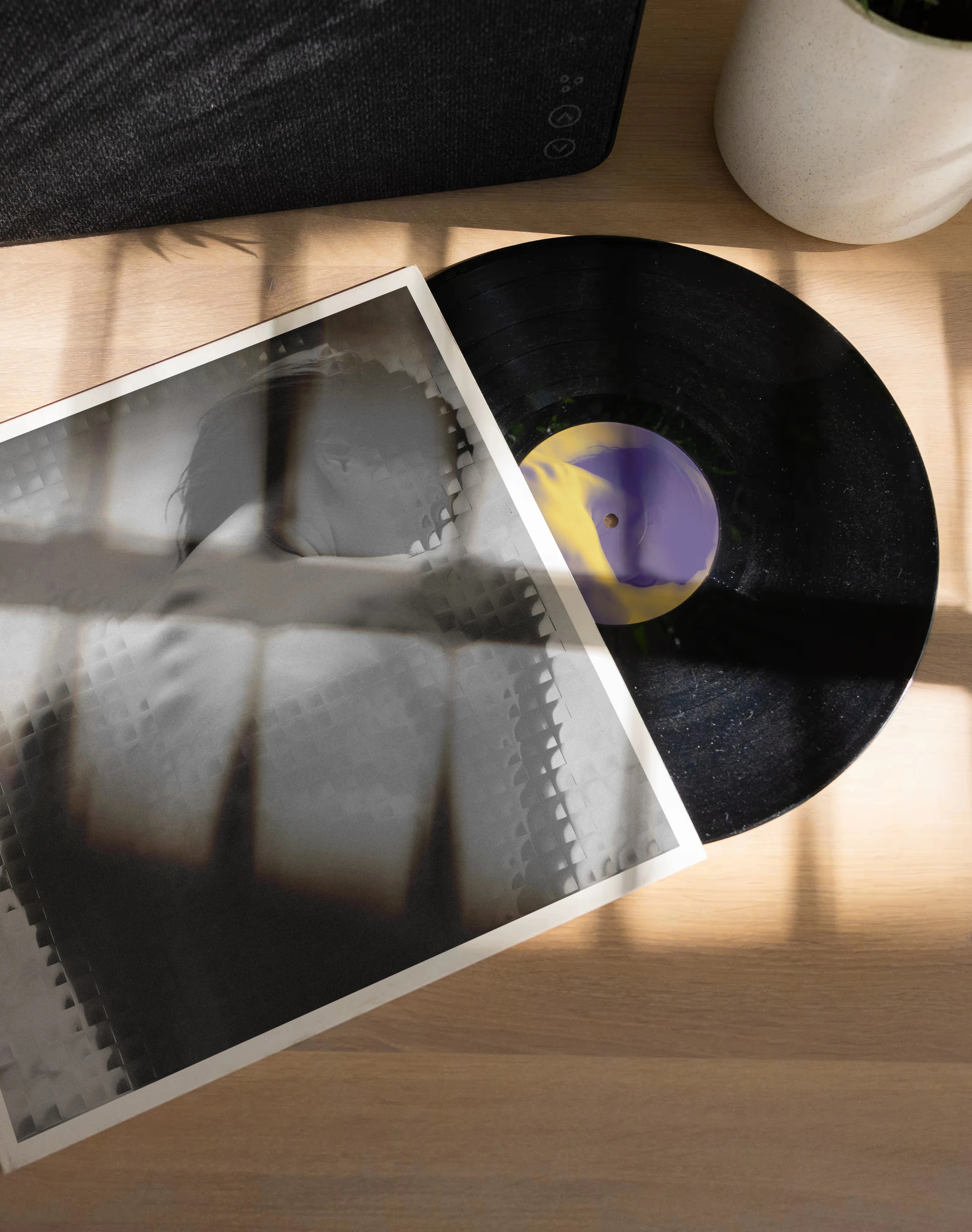 The sleeve and record on a sunlit table, light falling through a blind
